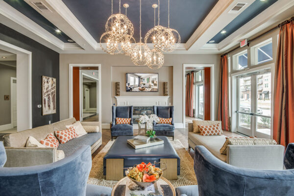 Clubroom with plush furniture, elegant decor, and large windows with bright natural light.