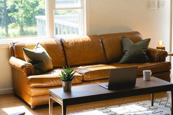 Living room with wood floor, coffee table, and elegant leather couch.