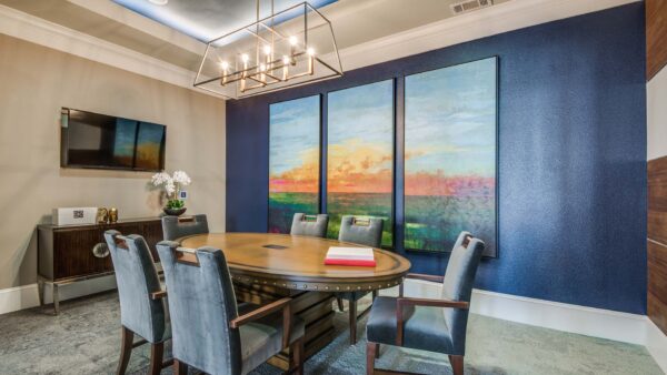 Shared dining space with seating and table at The Kathryn Frisco apartments.